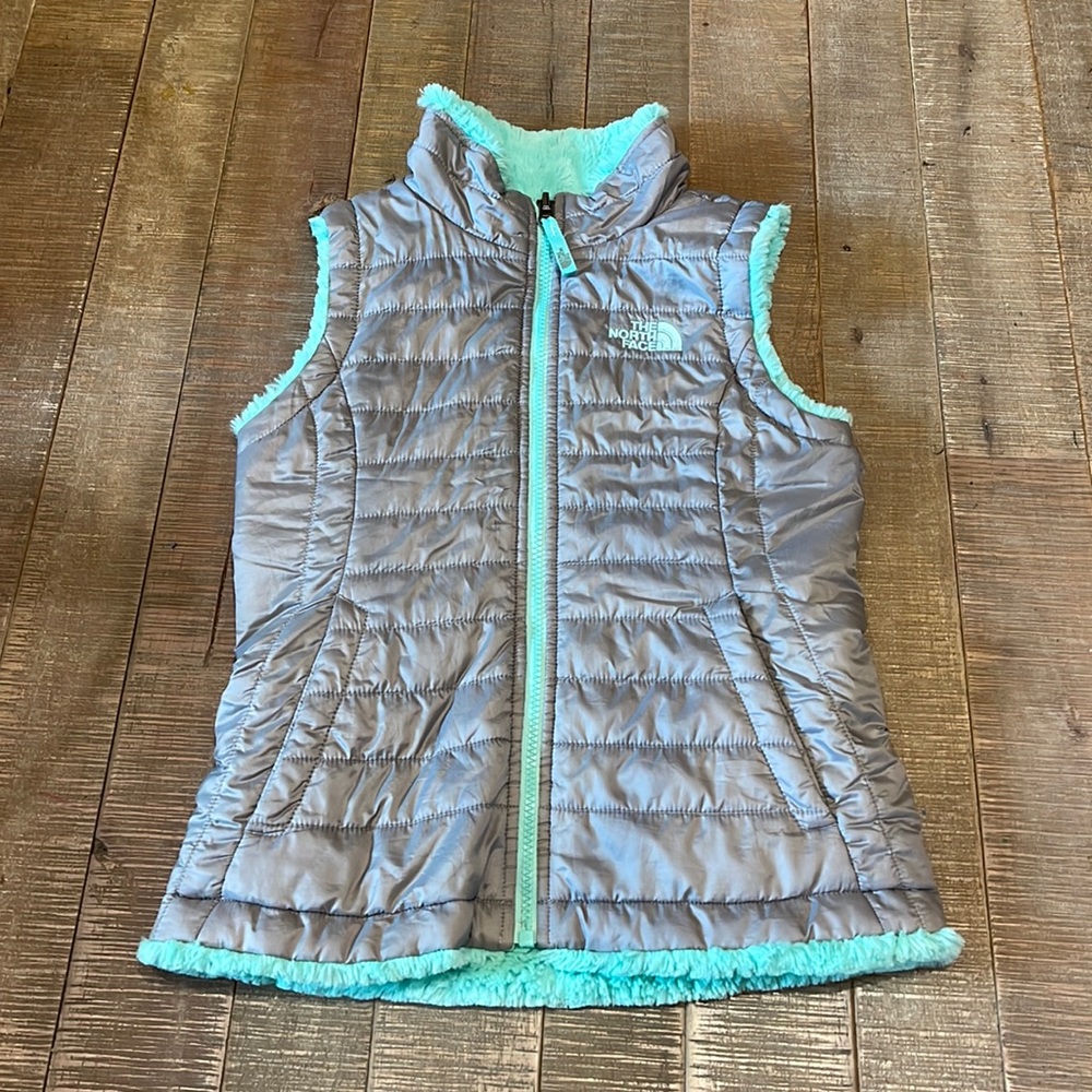 EUC North Face kids faux fur-lined reversible vest in gray and mint green.